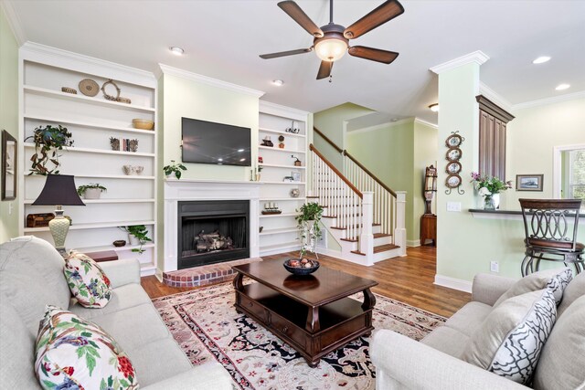 1119 Bruton Blvd, Moncks Corner, SC 29461 - living area with wood finished floors, a ceiling fan, recessed lighting, stairway, and a brick fireplace