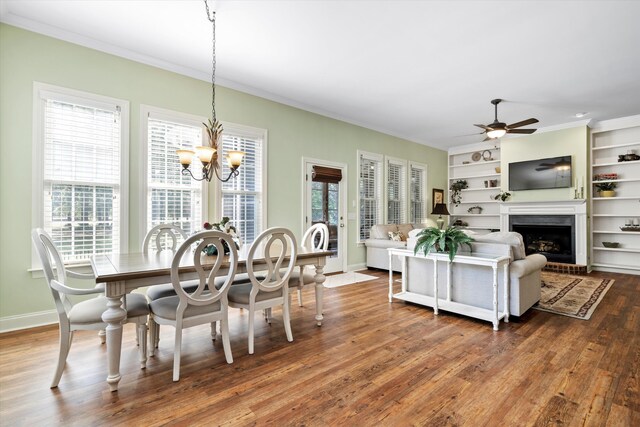 1119 Bruton Blvd, Moncks Corner, SC 29461 - dining room featuring a ceiling fan, wood finished floors, ornamental molding, baseboards, and a fireplace with raised hearth