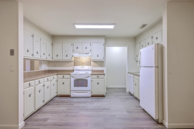 kitchen featuring white appliances, white cabinets, and light countertops