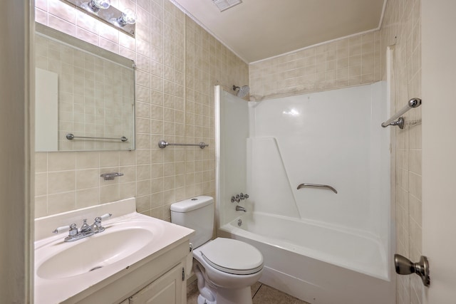 full bathroom featuring tile walls, toilet, vanity, washtub / shower combination, and tile patterned flooring