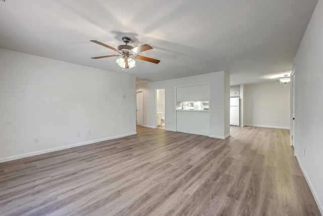 unfurnished living room featuring ceiling fan, wood finished floors, and baseboards
