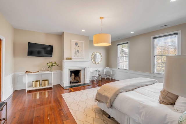 bedroom featuring multiple windows and hardwood / wood-style flooring