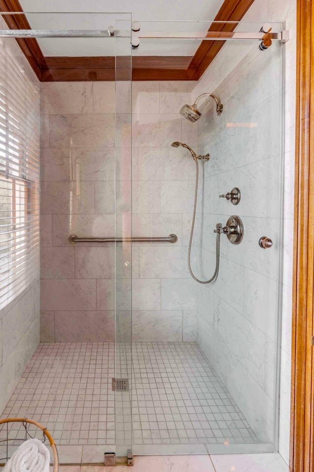 bathroom with crown molding and an enclosed shower