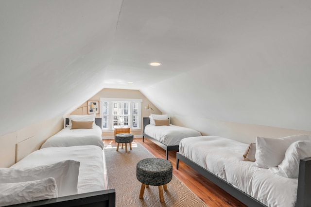 bedroom with wood-type flooring and vaulted ceiling