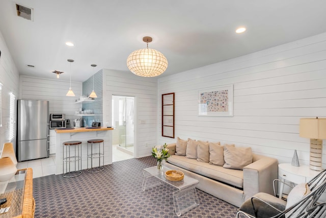 living room with wood walls