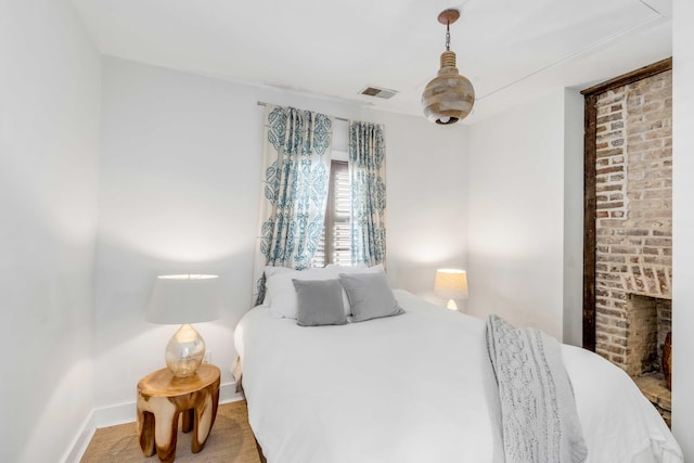 carpeted bedroom featuring a fireplace