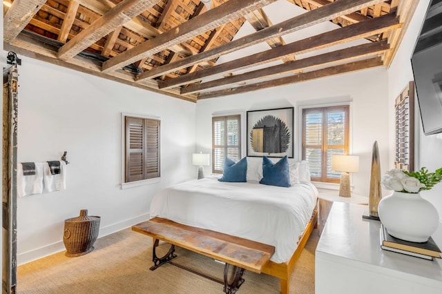 bedroom featuring lofted ceiling with beams