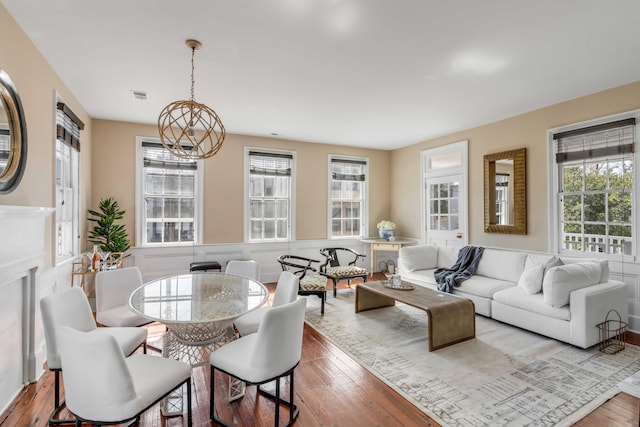 living room with a notable chandelier and light hardwood / wood-style floors