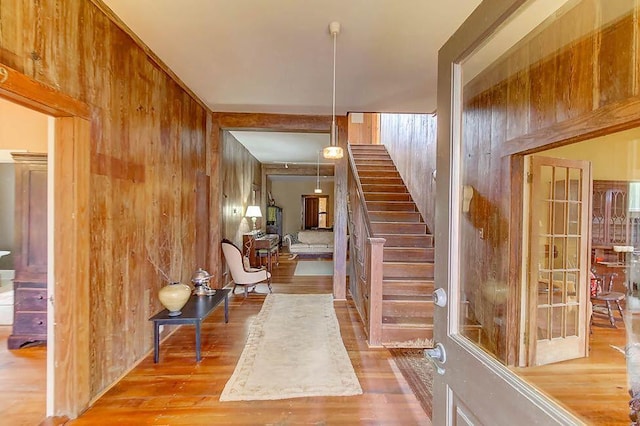 interior space with wooden walls and wood finished floors