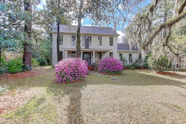 back of house featuring covered porch