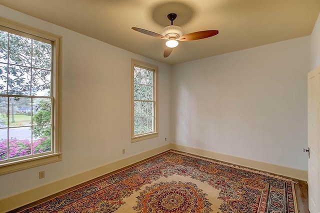 unfurnished room featuring baseboards and ceiling fan