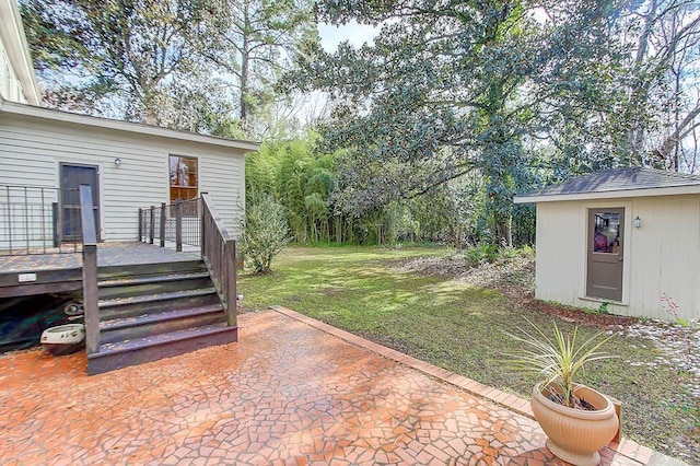 view of yard featuring a patio and an outbuilding