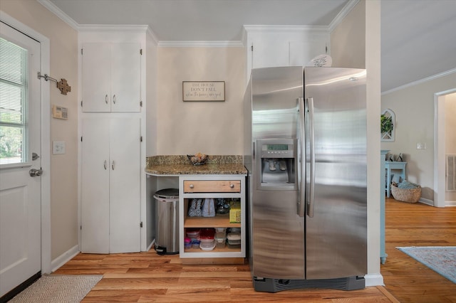 2220 Pinehurst Ave, Charleston, SC 29414 - kitchen featuring stainless steel fridge with ice dispenser, crown molding, light wood finished floors, dark stone countertops, and white cabinets