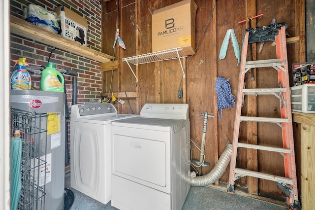 2220 Pinehurst Ave, Charleston, SC 29414 - clothes washing area featuring electric water heater, separate washer and dryer, and wooden walls