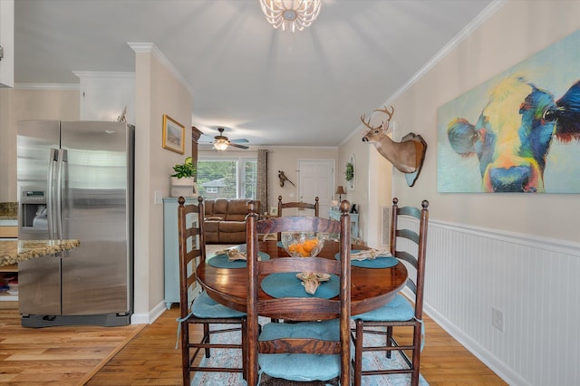 2220 Pinehurst Ave, Charleston, SC 29414 - dining space featuring light wood-style floors, crown molding, a wainscoted wall, and ceiling fan