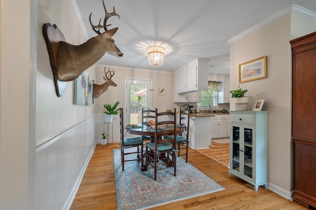 2220 Pinehurst Ave, Charleston, SC 29414 - dining room with crown molding, light wood-style flooring, and a chandelier