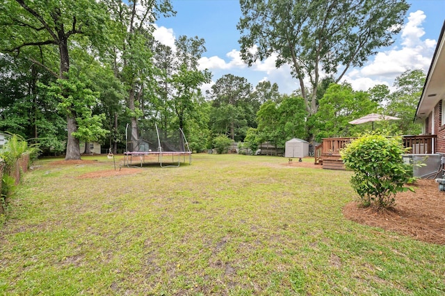 2220 Pinehurst Ave, Charleston, SC 29414 - view of yard with a trampoline, a shed, an outbuilding, a wooden deck, and view of wooded area