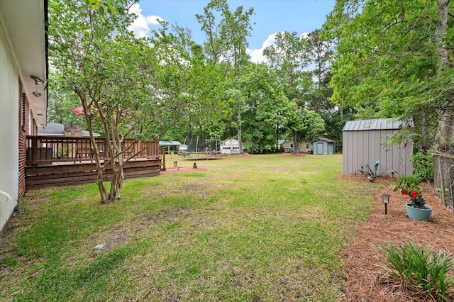 2220 Pinehurst Ave, Charleston, SC 29414 - view of grassy yard with a storage shed, an outbuilding, a wooden deck, and view of scattered trees