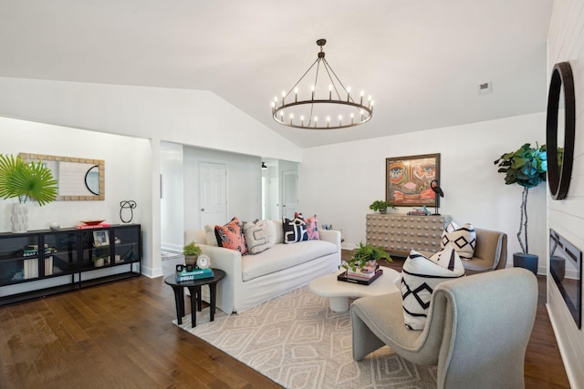 living room featuring an inviting chandelier, dark hardwood / wood-style flooring, and vaulted ceiling