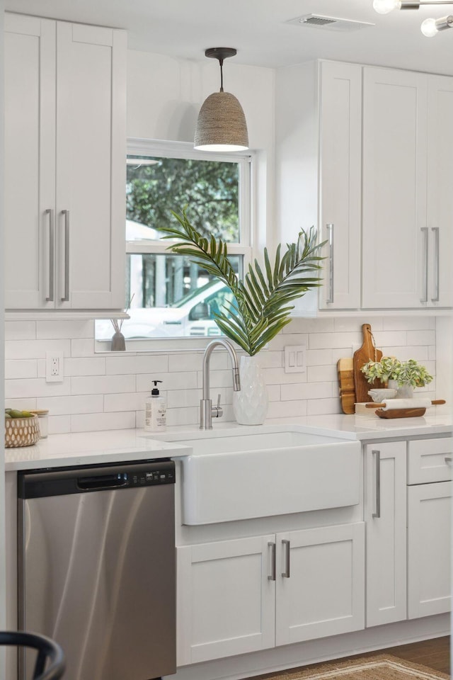 kitchen with sink, hanging light fixtures, white cabinets, decorative backsplash, and stainless steel dishwasher