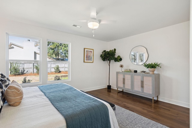 bedroom with dark hardwood / wood-style floors and ceiling fan