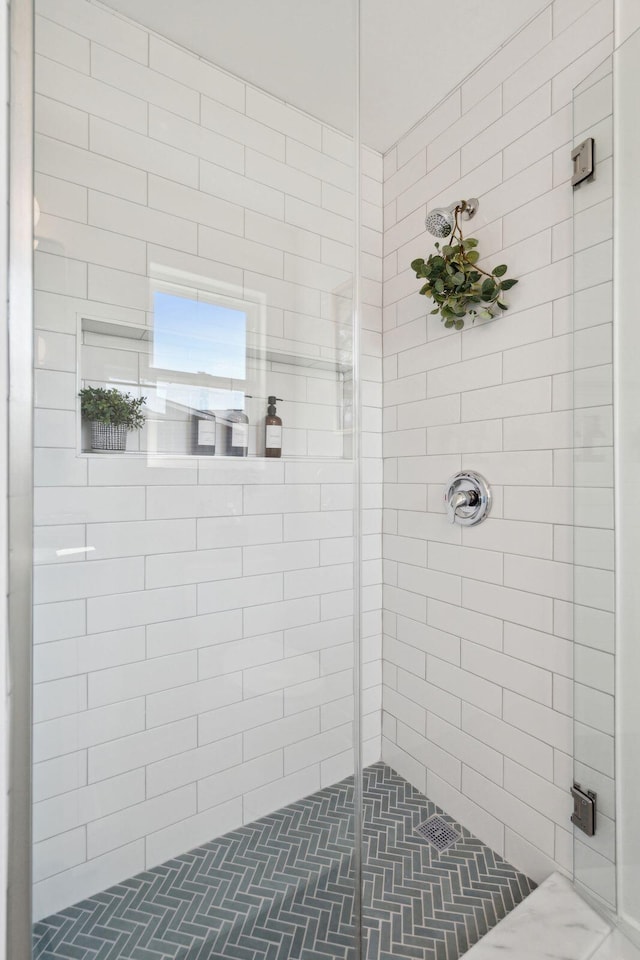 bathroom with a shower with door