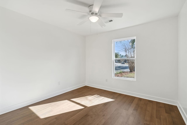 unfurnished room featuring ceiling fan and dark hardwood / wood-style flooring