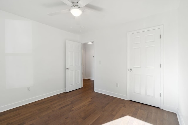 unfurnished bedroom featuring dark hardwood / wood-style floors and ceiling fan