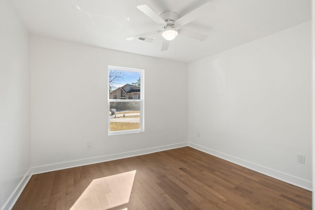 spare room featuring hardwood / wood-style floors and ceiling fan