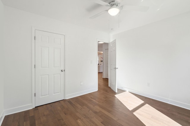 unfurnished bedroom featuring ceiling fan and dark hardwood / wood-style flooring