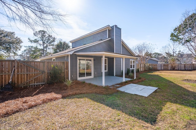 back of property featuring a patio area and a lawn