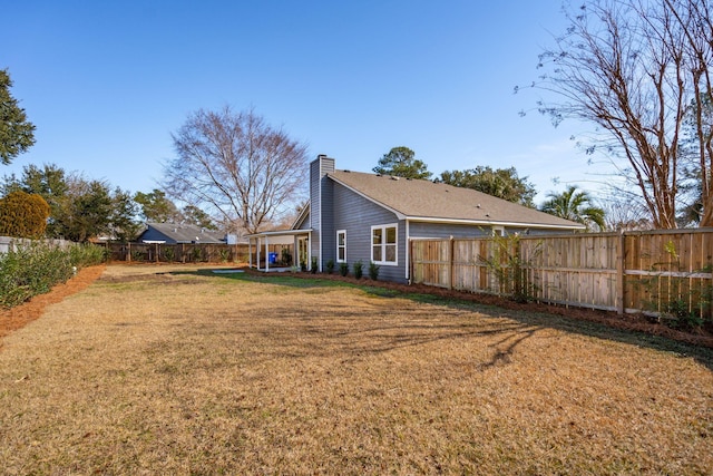 back of house featuring a yard