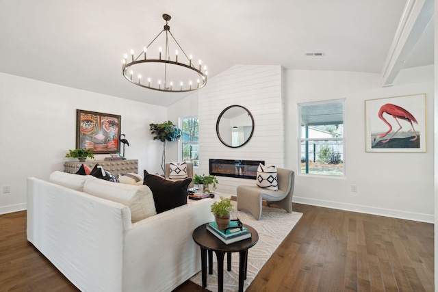 living room with lofted ceiling, dark hardwood / wood-style floors, a wealth of natural light, and a large fireplace