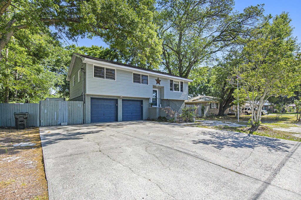 14 Newark Ave, Goose Creek, SC 29445 - bi-level home featuring a garage, concrete driveway, and fence