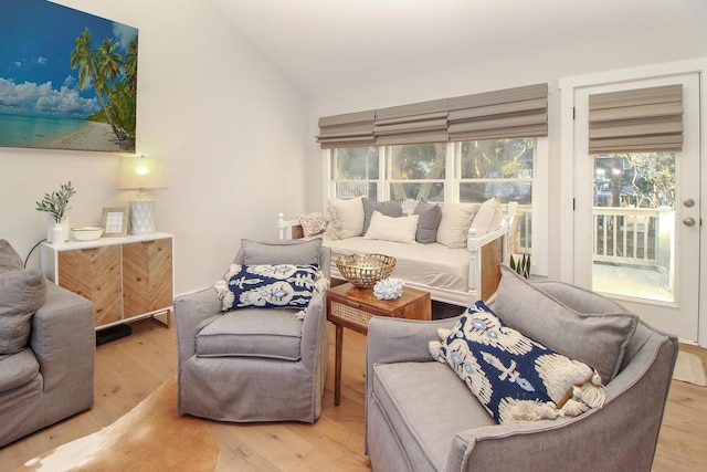 living area with vaulted ceiling and wood finished floors