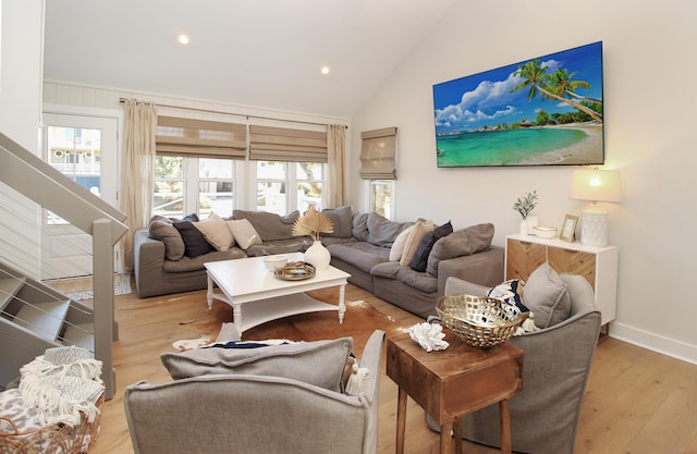 living area with high vaulted ceiling, recessed lighting, baseboards, and wood finished floors