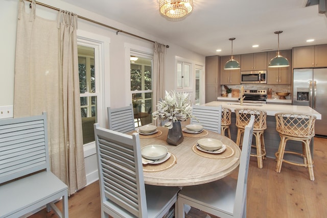 dining area featuring light wood-type flooring and recessed lighting