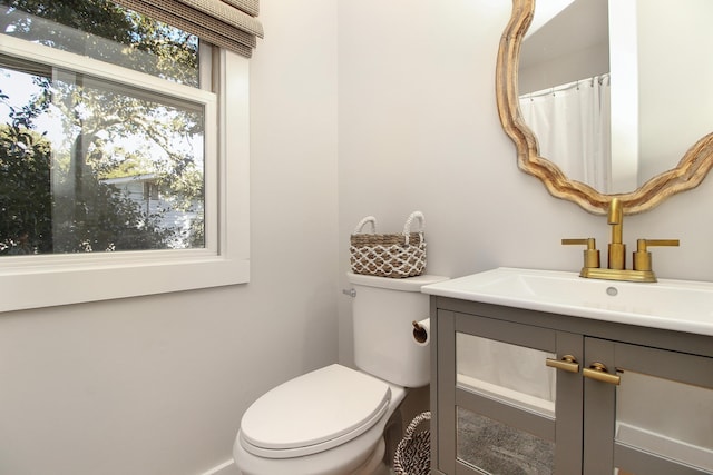 full bath featuring vanity and toilet