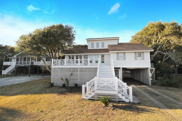 view of front of property with driveway, stairs, a front lawn, and a carport