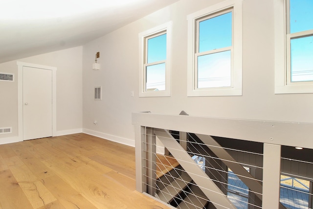 interior space with visible vents, baseboards, and wood finished floors