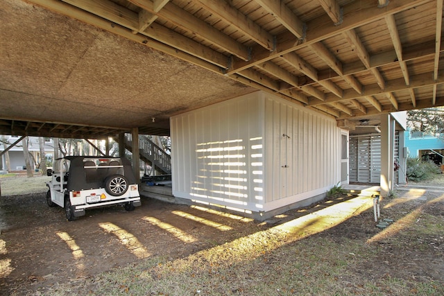 exterior space with an attached carport and stairs