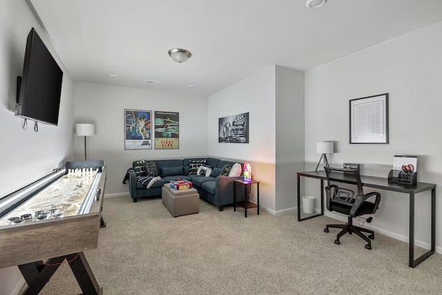 living area featuring carpet flooring, baseboards, and an office area