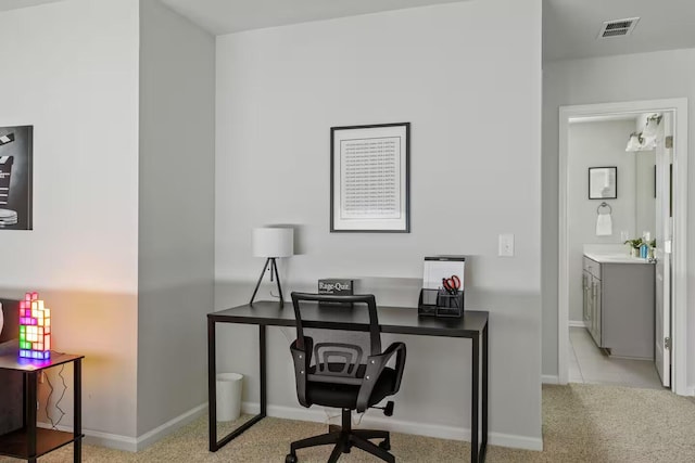 office space featuring baseboards and light carpet