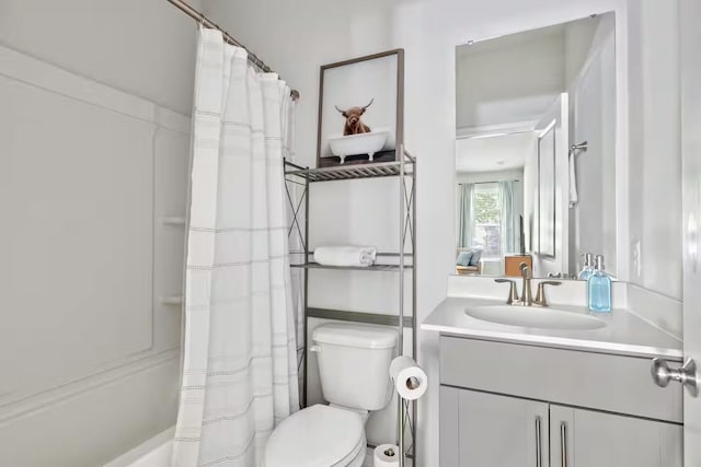 full bathroom with toilet and vanity