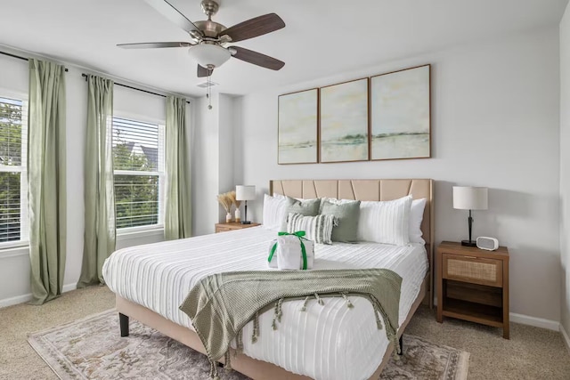 carpeted bedroom featuring baseboards and ceiling fan