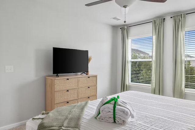 bedroom featuring a ceiling fan and baseboards