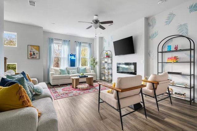 living area featuring ceiling fan and wood finished floors