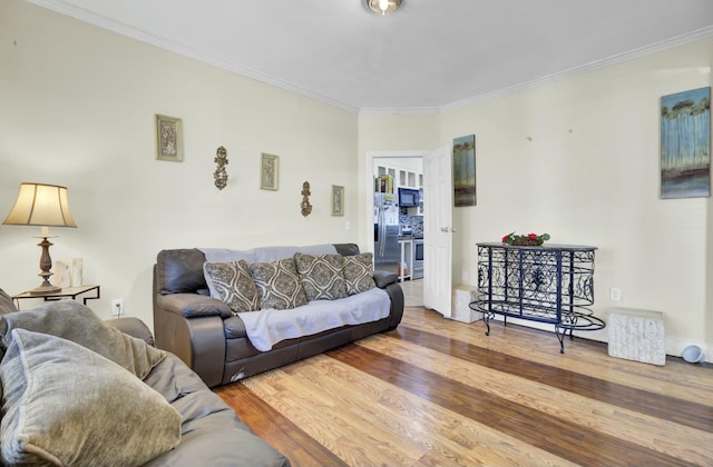 living area featuring wood finished floors and crown molding