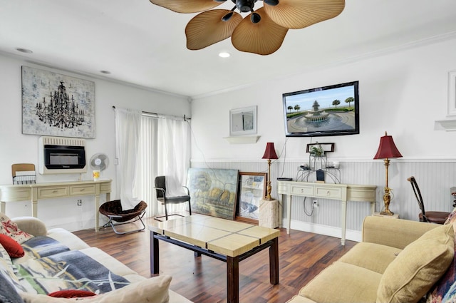 living area featuring heating unit, wood finished floors, recessed lighting, and ornamental molding