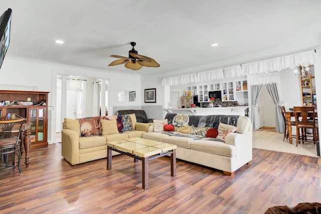 living area with crown molding, recessed lighting, wood finished floors, and ceiling fan